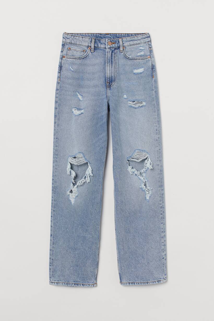 A picture of blue, straight pants with fake rips on them, these fake rips have more fabric under them.