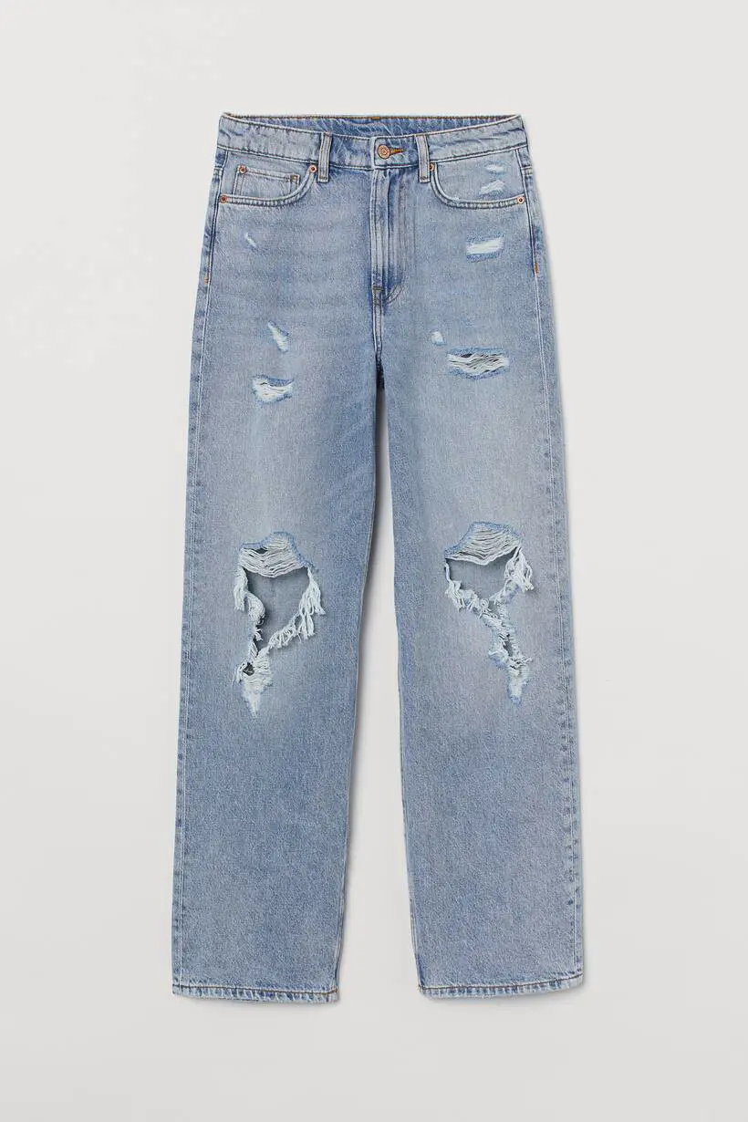 A picture of blue, straight pants with fake rips on them, these fake rips have more fabric under them.